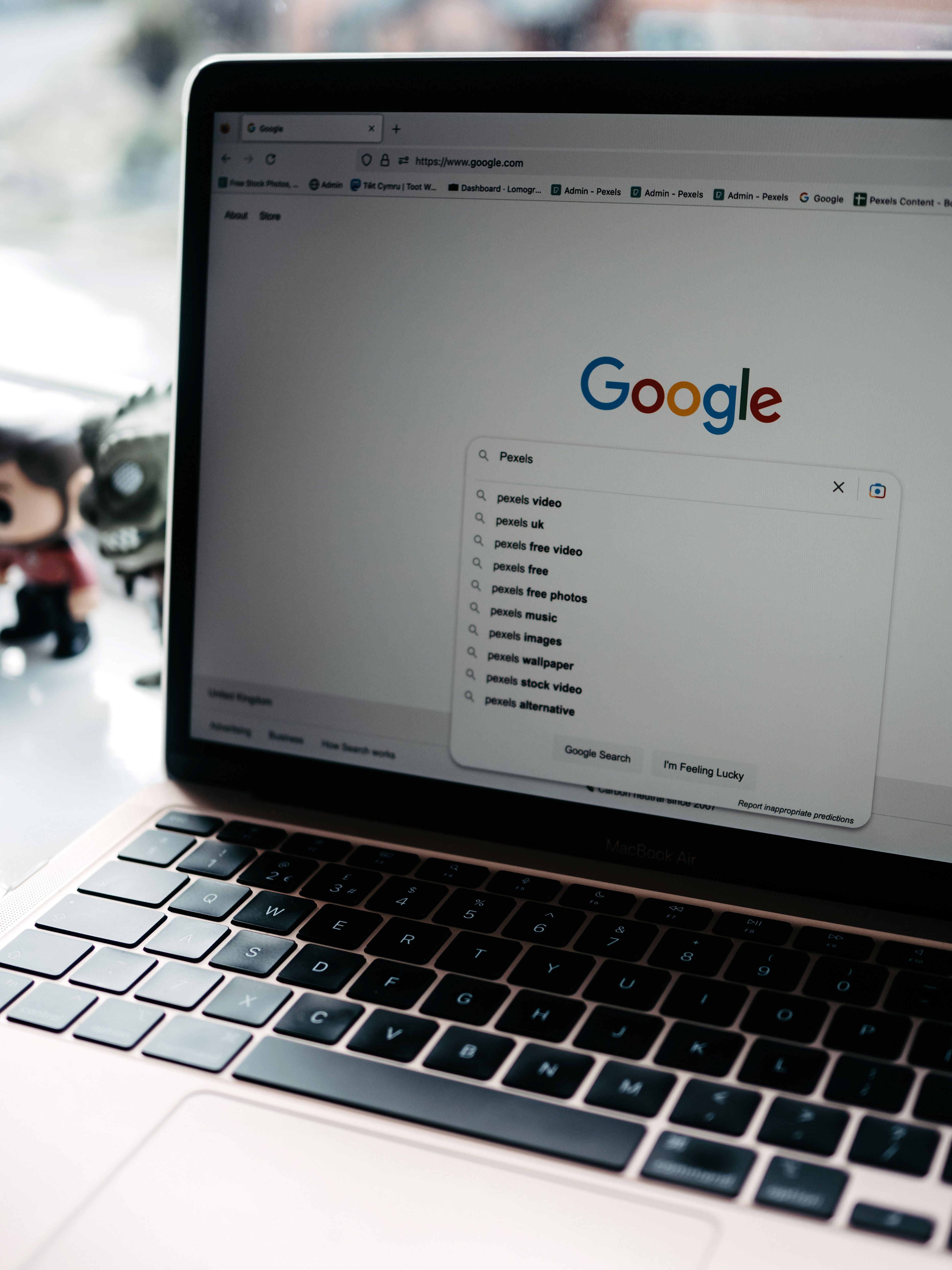 A close-up shot of a laptop displaying a Google search page with related searches visible.
