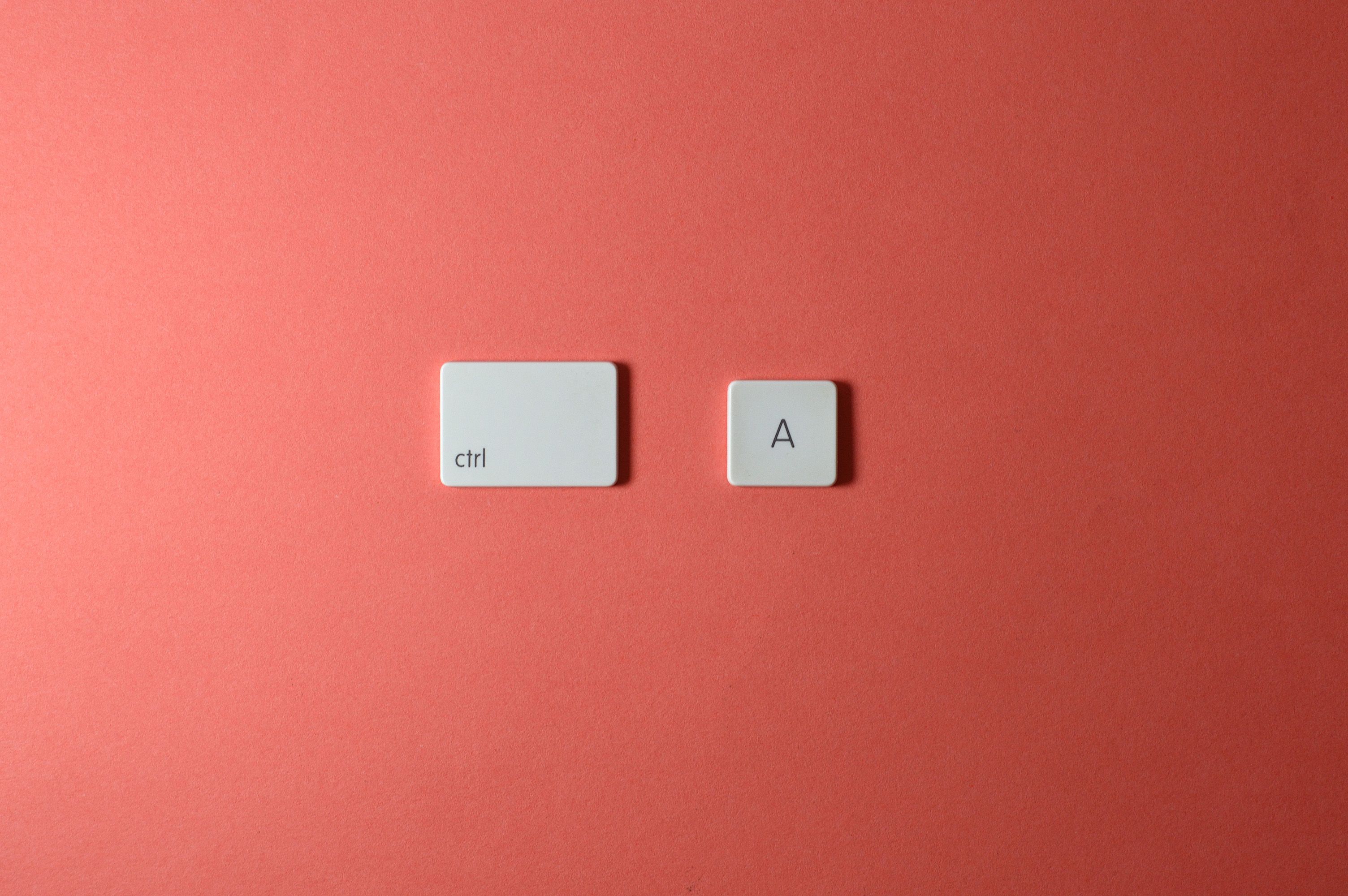 White ctrl and A keys on a simple red background create a minimalist and modern look.