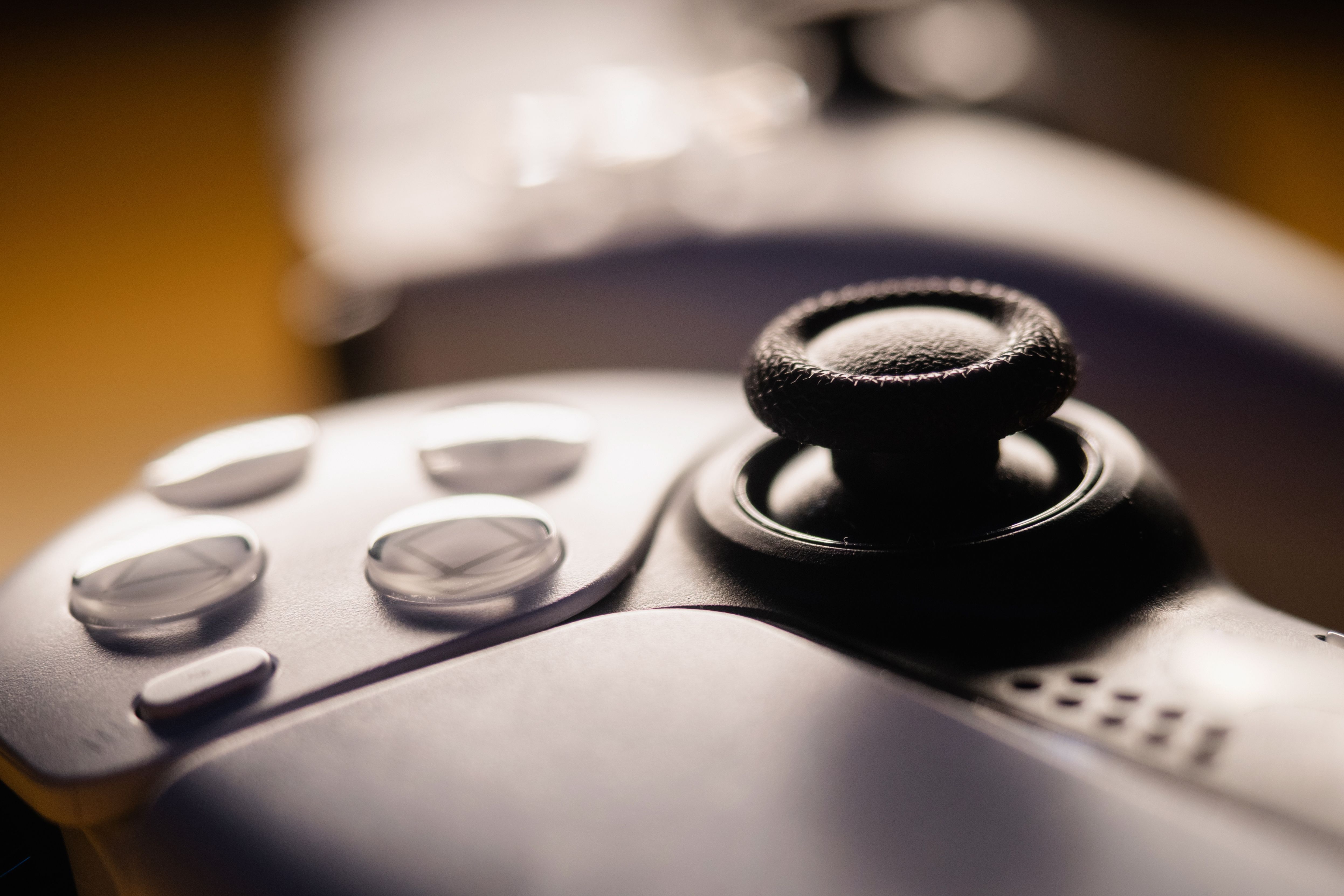 Detailed close-up of a video game controller with focus on buttons and joystick.